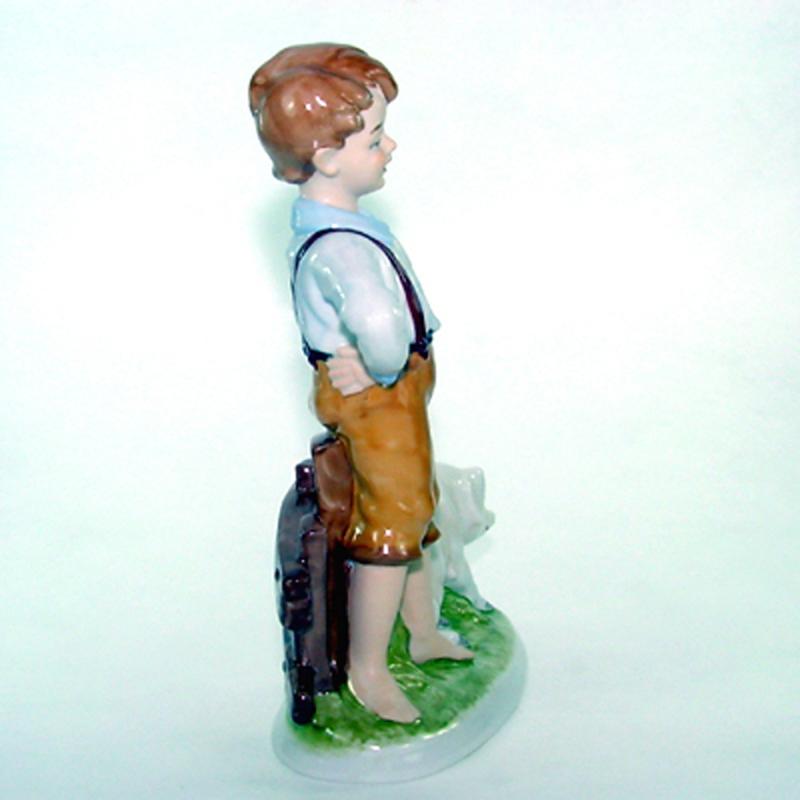 Boy with Pig - porcelain H 22 cm